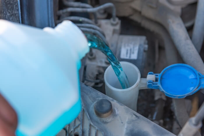 Refilling washer fluid of a passenger car