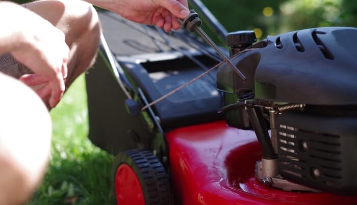 Checking the oil level of a lawn mower